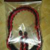 red and black in the package bow sling